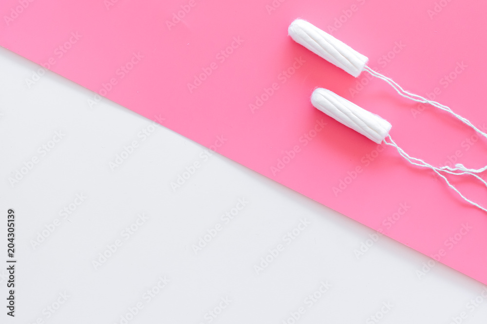 Woman hygiene protection. Cotton tampons on pink background top view copy space Woman hygiene protection. Cotton tampons on pink background top view copy space