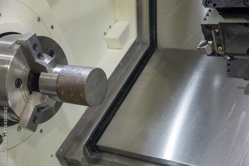 The CNC lathe machine chucking the raw material for turning process.The