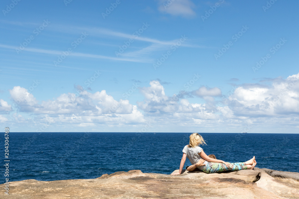 Couple watching the ocean from a cliff