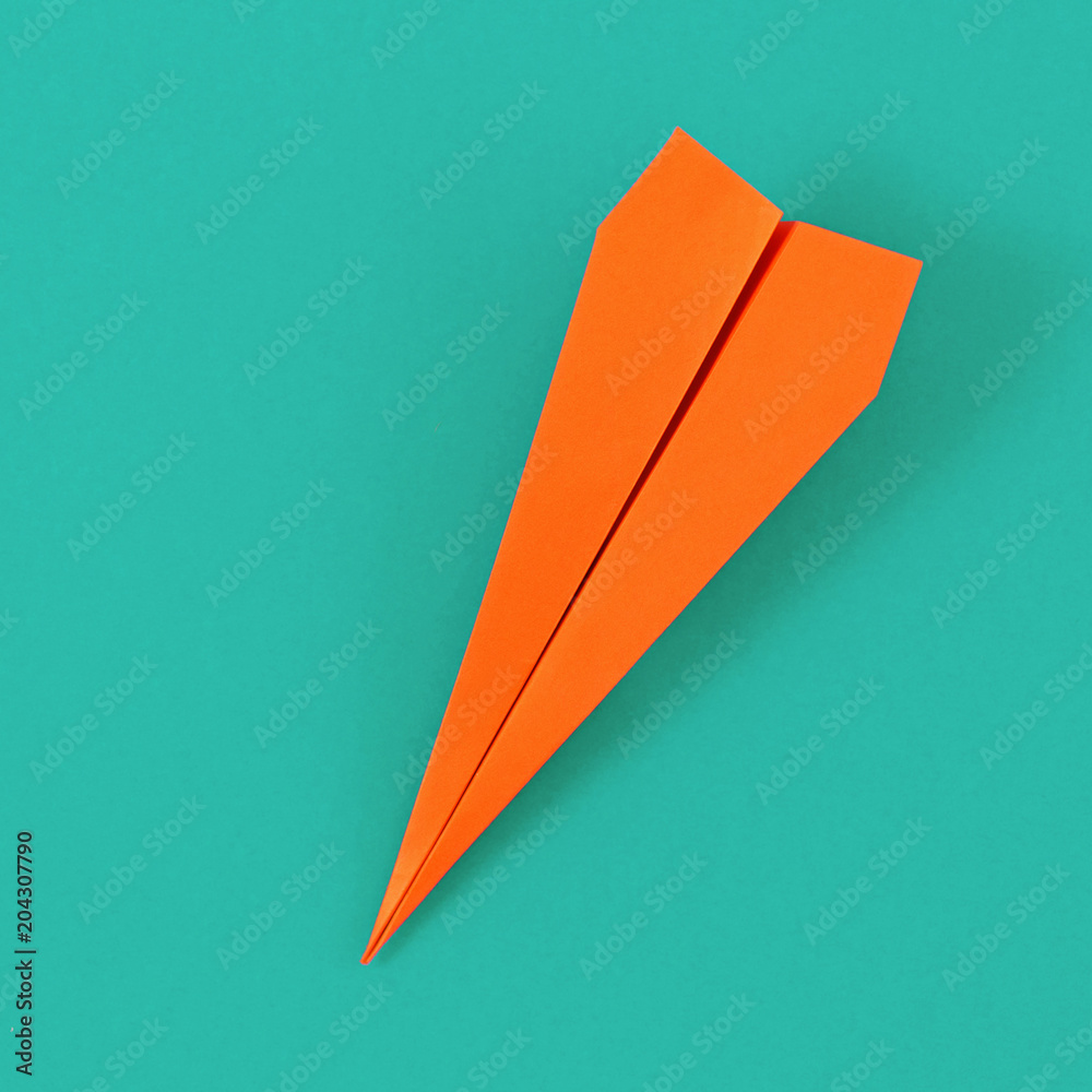 Flat lay colorful paper plane on pastel turquoise background. Top view creative travel background concept - obrazy, fototapety, plakaty 