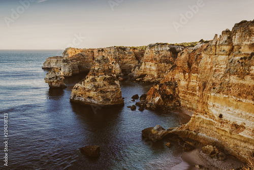 Lovely evening with a view of the ocean and cliffs. Praia da Marina. Region Algarve. Portugal