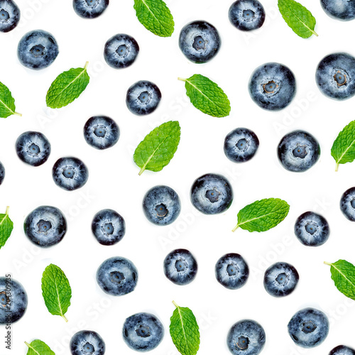 Creative pattern made of blueberries with leaves. Fresh berry fruits isolated on white background. Flat lay. Food concept..