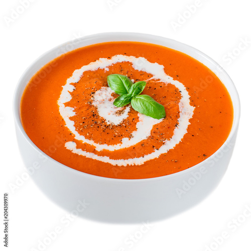  Tomato Cream  Soup  in a white bowl with herbs isolated on white background. Autumn soup.
