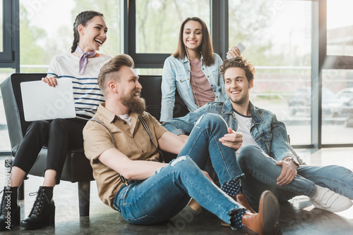 Successful business people sitting and resting together in modern light office