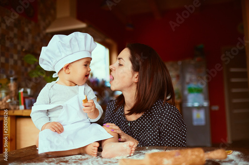 The mother with son eatting cookies  in the kitchen