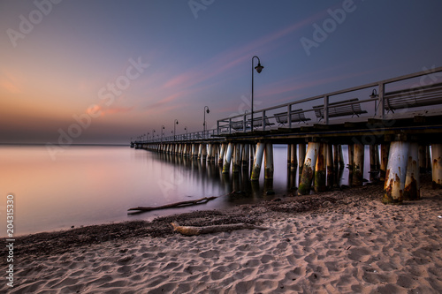 Amazing colorful sunrise over the pier in Gdynia Orlowo. Sunrise over the sea.