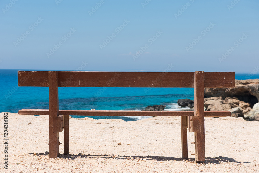 Wooden empty bench with a majestic sea view Wooden empty bench with a majestic sea view