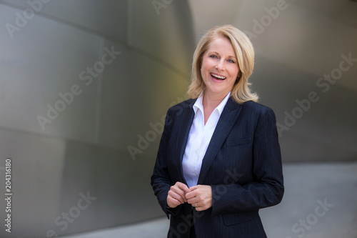 Genuine sincere portrait of a beautiful experienced business woman, investor, professional attire