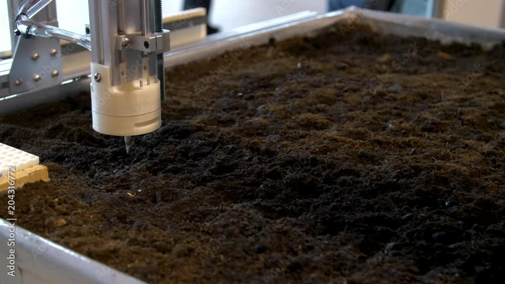 The production robots planting seeds in the soil at a modern technology exhibition and robotics in Russia. The production robots planting seeds in the soil at a modern technology exhibition and robotics in Russia.