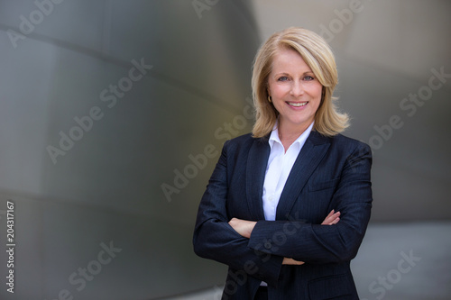 Confident and successful CEO business woman in a suit with arms folded photo