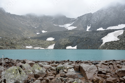 Russia, The Altai mountains, upper Acchan (Akchan) lake in overcast weather photo