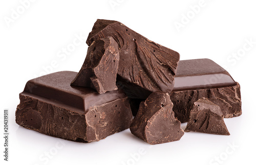 Fototapete Pieces of dark chocolate isolated on white background.