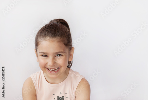 Portrait of a happy smiling child girl. True emotions. Space for text.