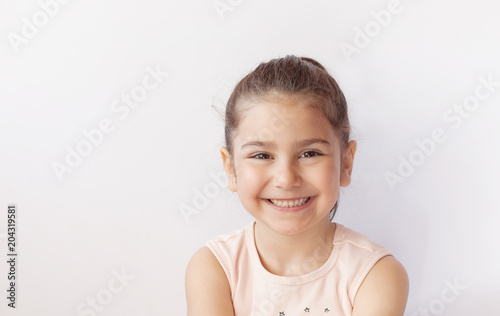 Portrait of a happy smiling child girl.