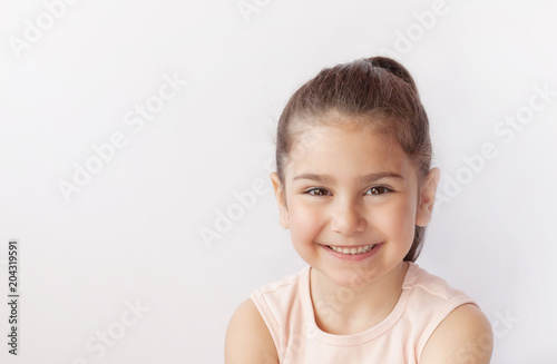 Fototapeta Portrait of a happy smiling child girl.