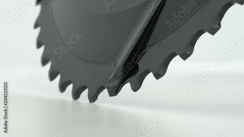 Black oval bicycle chainring gear rotating at white background, strong close up with visible details of structure photo