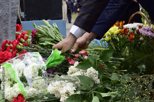 Bouquet of red carnations in man hand at Victory Day celebrations