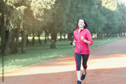 Portrait of elderly woman running in the park