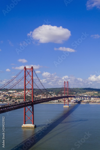 Ponte 25 de Abril Bridge in Lisbon, Portugal. Connects the cities of Lisbon and Almada crossing the Tagus River. View from Almada with Lisbon across the river.
