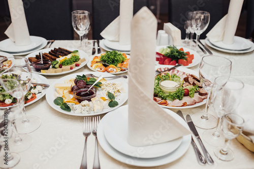 catering table set service with silverware and glass stemware at
