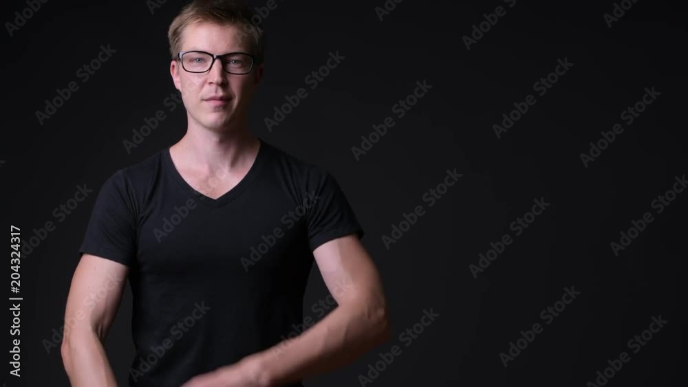 Young handsome man against black background Young handsome man against black background