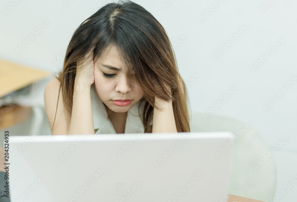 Selective focus tired young business woman with laptop computer, office syndrome concept. Selective focus tired young business woman with laptop computer, office syndrome concept.