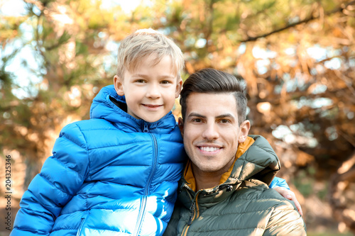 Young man and little boy ou...