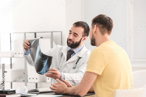 Doctor consulting male pati...