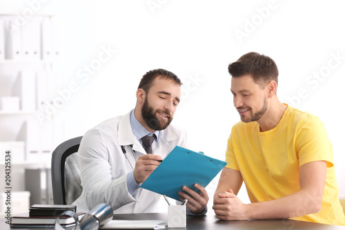 Doctor consulting male pati...