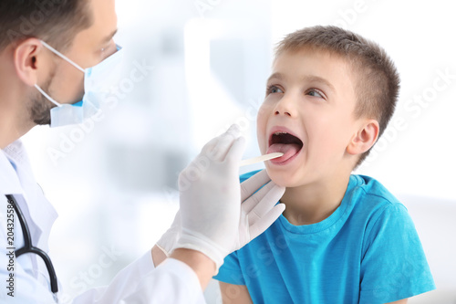 Children's doctor examining...