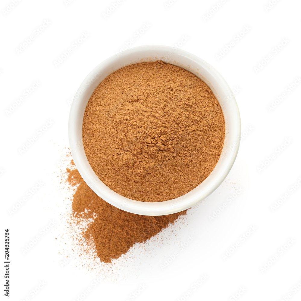 Bowl with aromatic cinnamon powder on white background Bowl with aromatic cinnamon powder on white background