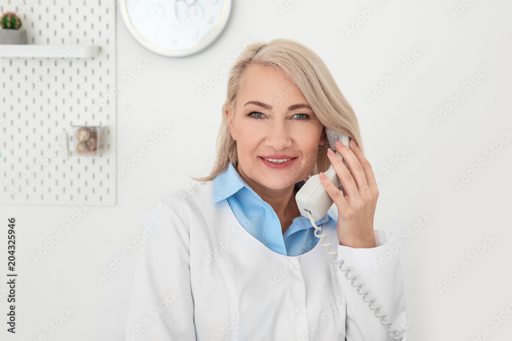 Senior female receptionist working in hospital Senior female receptionist working in hospital