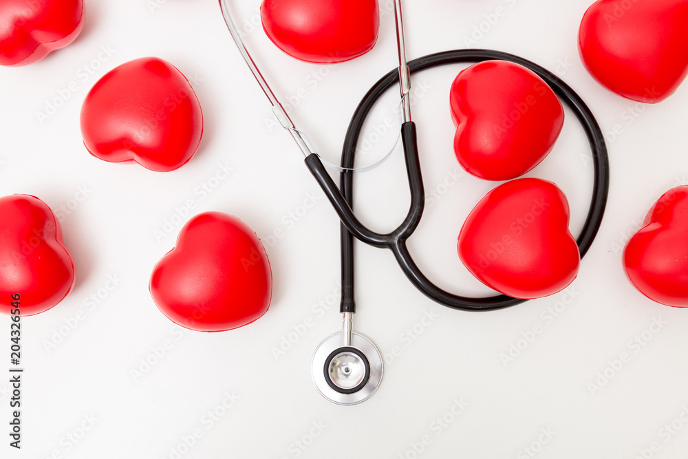 Red heart and a stethoscope. Isolated on white background. Studio lighting. Concept for healthy and medical Red heart and a stethoscope. Isolated on white background. Studio lighting. Concept for healthy and medical