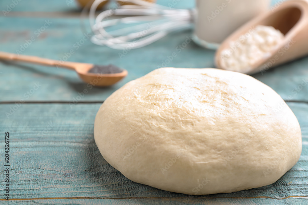 Fresh raw dough on wooden table Fresh raw dough on wooden table