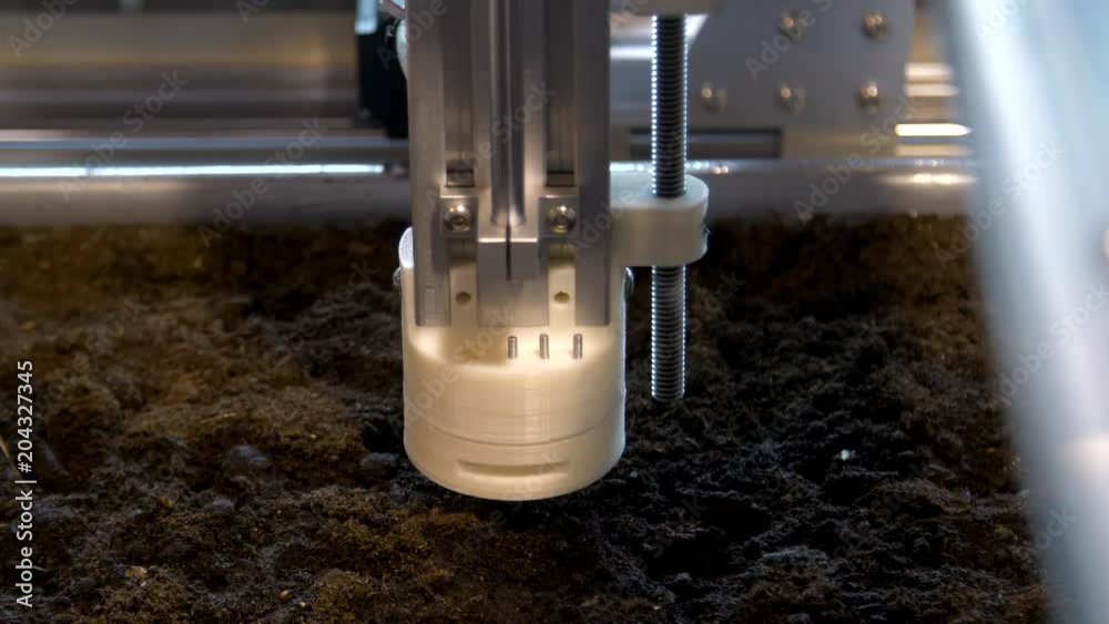 The production robots planting seeds in the soil at a modern technology exhibition and robotics in Russia.