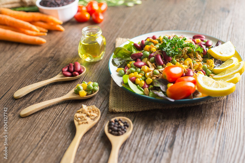 Healthy food background : salad bowl on wooden table.
