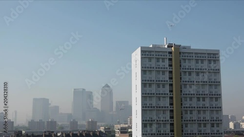 Wallpaper Mural UK May 2018 - Passenger jet planes pass over Canary Wharf financial district which is shrouded in smog as London suffers a “Code Red” air pollution warning. Torontodigital.ca