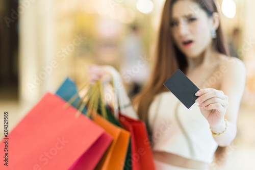 Beautiful woman holding shopping bags and credit , over payment concept.