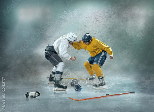 Caucassian ice hockey Players in dynamic action in a professional sport game play on the laptop in hockey under stadium lights.