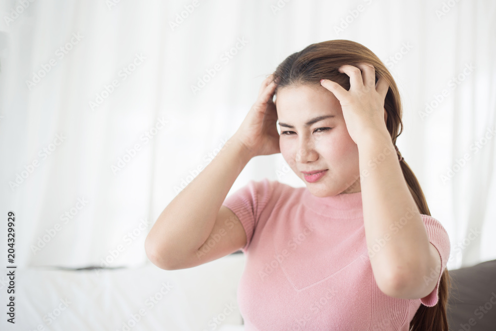 Young asian woman touching her Head on the bed. Woman sick concepts : headache, dizziness, nasea. Young asian woman touching her Head on the bed. Woman sick concepts : headache, dizziness, nasea.