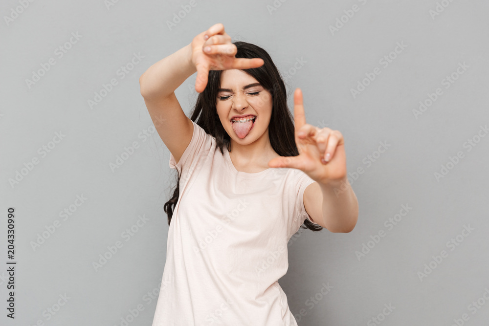 Young lady take a shot of you gesturing with hands Young lady take a shot of you gesturing with hands