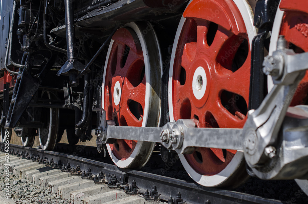 large red wheels of a locomotive large red wheels of a locomotive