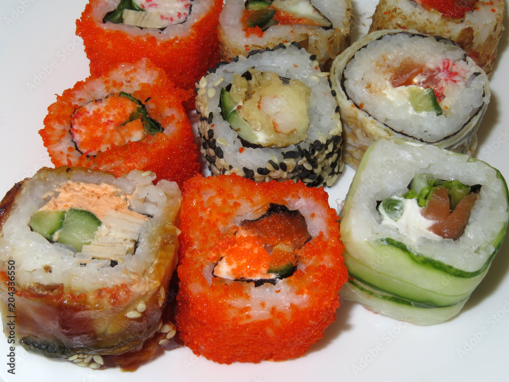 Various kinds of sushi rolls on white background Various kinds of sushi rolls on white background