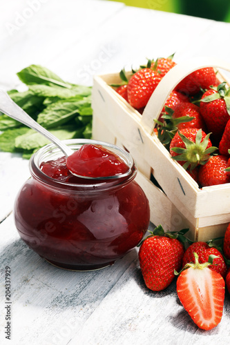 Strawberry jam in a jar and fresah strawberries. photo