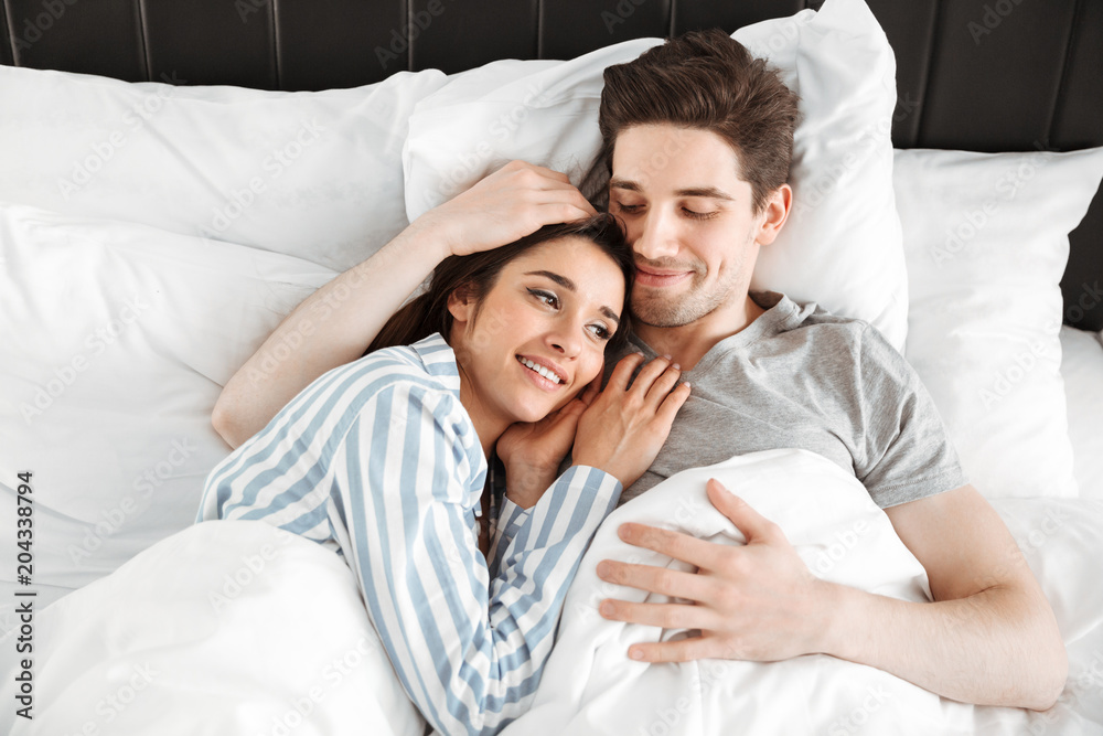 Portrait of a happy young couple lying together Portrait of a happy young couple lying together