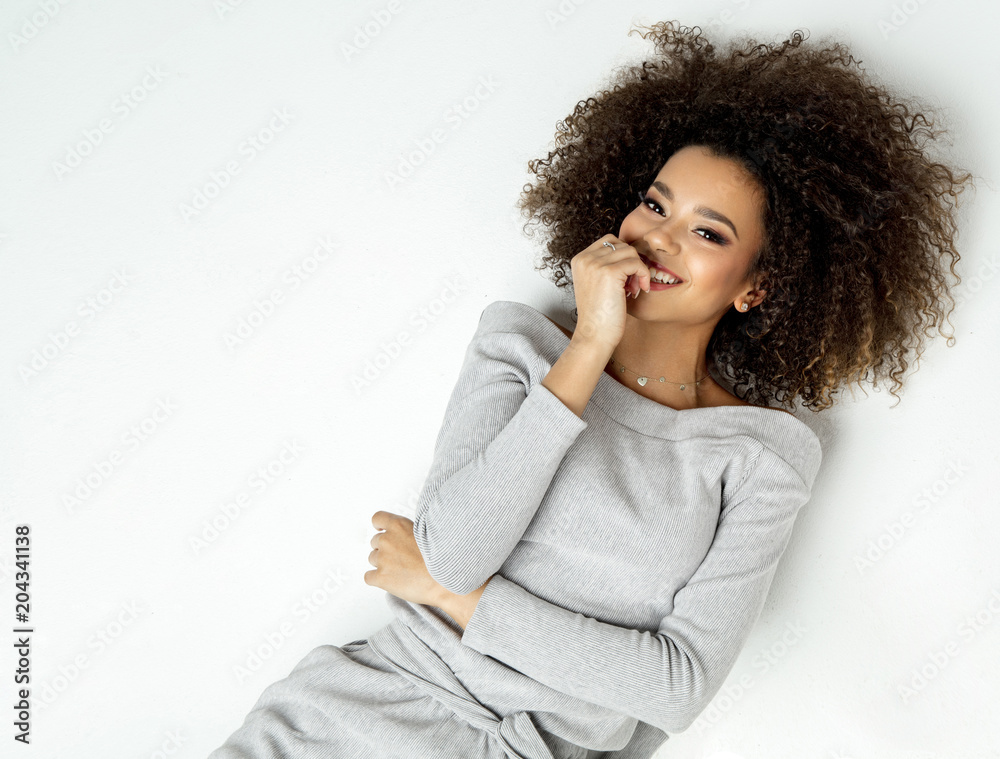 Portrait Of Beautiful Smiling Black Woman With Fresh Face, Soft Skin Having Fun Lying On White Background Portrait Of Beautiful Smiling Black Woman With Fresh Face, Soft Skin Having Fun Lying On White Background