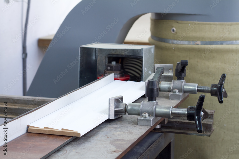 Press bonding. Metal glue press for wood frame on fixed table.