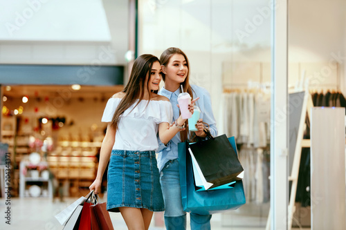 Girls Shopping. Female Friends In Mall photo