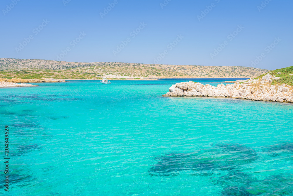 White Island, Aspronisi, Leros Island, Dodecanese, Greece: Amazing view to maldives beach bay like small greek island with crystal clear turquoise blue water some boats cruising and people swimming