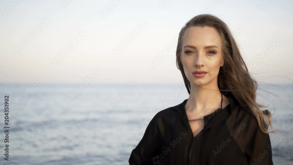 Portrait of beautiful girl on beach at sunset Portrait of beautiful girl on beach at sunset